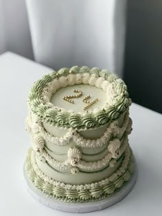 there is a wedding cake that has been decorated with green and white icing on it