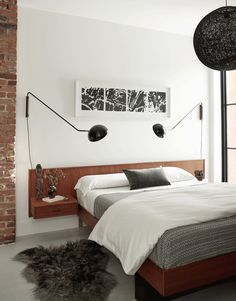 a bedroom with white walls and black accents