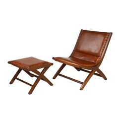 two brown leather chairs and a small wooden table