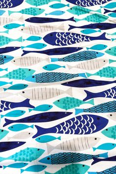 a blue and white fish print fabric with different colors on the bottom half of it