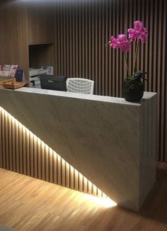 a reception counter with flowers on it