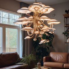 a living room filled with furniture and a large chandelier hanging from the ceiling