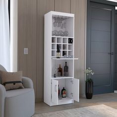 a living room filled with furniture and a tall white shelf next to a chair on top of a hard wood floor