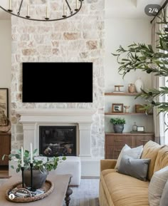 a living room filled with furniture and a flat screen tv mounted on the wall above a fireplace