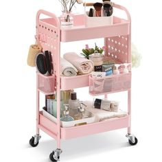 a pink trolley with lots of items on it's wheels and shelves in front of a white background