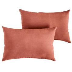 two orange pillows sitting next to each other