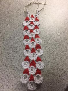 a crocheted santa clause hanging on the wall