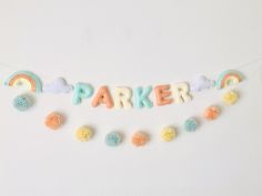 the word parker spelled out with pom - poms in front of a white background