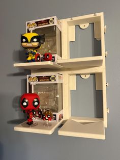 two shelves with pop figures on them in the shape of deadpool and wolverineman