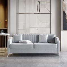 a living room with a couch, table and two lamps on the wall above it