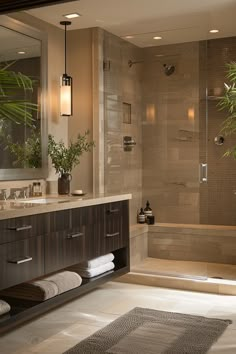 a bathroom with two sinks and a bathtub next to a large mirror on the wall