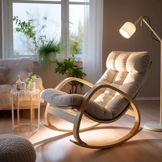 a living room with a rocking chair and lamp on the floor next to a window