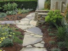 a stone path in the middle of a garden