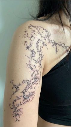 a woman's arm with an intricate tattoo design on the left side of her body