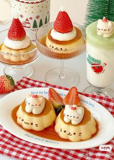 some desserts are sitting on a table with strawberries and other items in the background