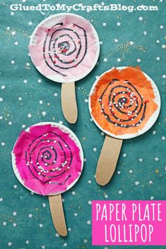 three paper plate lollipops are sitting on top of a blue surface with stars