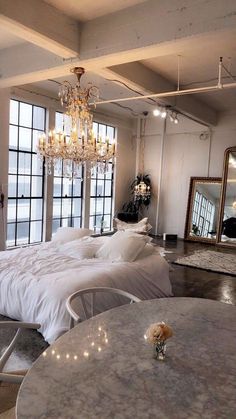 a bedroom with two beds and a chandelier