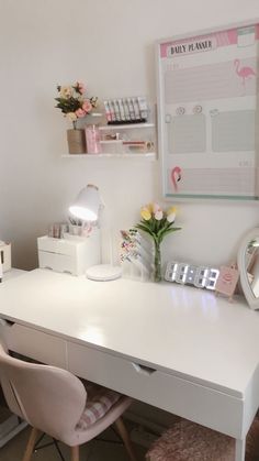 a white desk with two chairs next to it and a pink flower vase on top