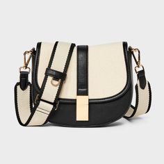 This Saddle Crossbody Bag from A New Day™ with a structured silhouette features a roomy main compartment and an interior zip pocket for easy organization of your belongings, plus an overlapping flap with a gold-tone buckle accent and magnetic closure. Plus, the detachable adjustable shoulder strap makes carrying a breeze whether you sling it over one shoulder or carry it in hand. A New Day™: Style that goes wherever you do. A New Day Crossbody Bag, Cheap Crossbody Box Bag For Daily Use, Cheap Satchel With Detachable Strap For Shopping, Cheap Designer Bags For Everyday Use, Cheap Trendy Handheld Bags, Crossbody Bag Short Strap, Cheap Everyday Bags With Gold-tone Hardware, Cheap Chic Crossbody Box Bag, Black Bags Women Nordstrom