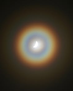 the moon is seen through an object in the sky