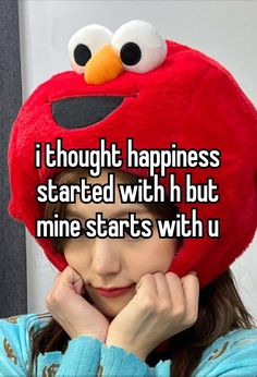 a girl with a red hat that says i thought happiness started with h but mine starts with u