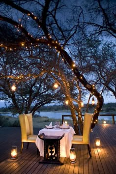 an outdoor dining area with candles and lights