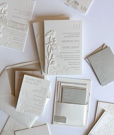 the wedding stationery is laid out on top of each other