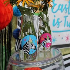 three vases filled with flowers sitting on top of a table