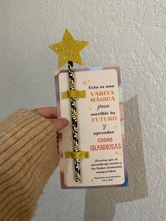 a person holding up a card with a cross on it and a star above it