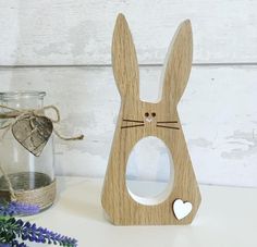 a wooden bunny shaped mirror next to a jar