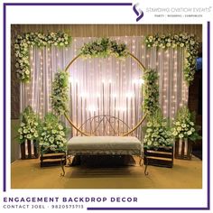 an event backdrop with white flowers and greenery