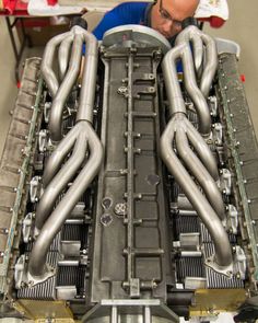 a man working on an engine in a garage