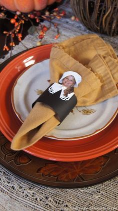 an orange and white plate with a napkin on it that says, fun place card ideas for thanksgiving