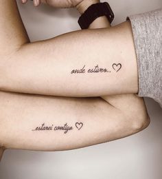 two people with matching tattoos on their arms, one has the words and the other says