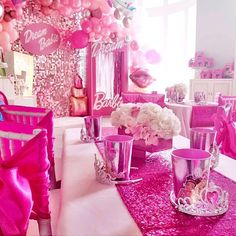 the table is set with pink and white decorations