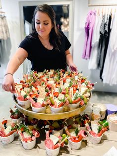 a woman standing in front of a large platter of food