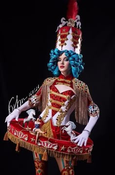 a woman dressed in red, gold and white is posing for the camera with her hands on her hips