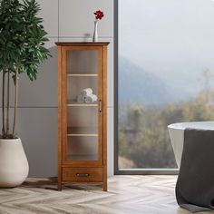 a wooden cabinet sitting next to a bath tub in a room with a large window