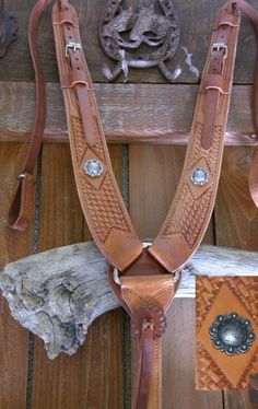 a close up of a horse's bridle on a wooden floor with other items