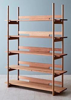 a wooden shelf with several shelves on each side and two rows of bookshelves in the middle