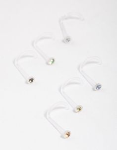 five pairs of nose rings on a white surface