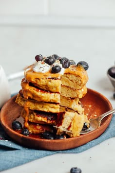 stack of pancakes with blueberries and whipped cream