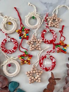 various beaded ornaments are displayed on a marble counter top, including wreaths and beads