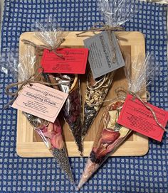 four different types of dried fish on a tray with tags attached to them and wrapped in plastic