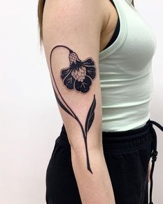 a woman with a flower tattoo on her arm