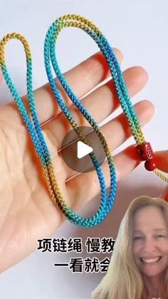 a woman is smiling and holding two bracelets with beads on each strand in different colors