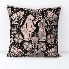 a black and pink pillow with an image of two bears