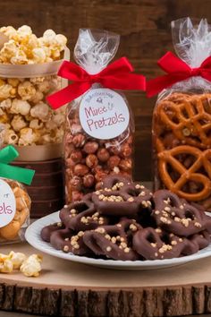 a table topped with lots of different types of snacks and pretzels next to each other