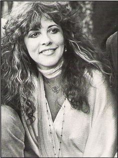 a black and white photo of a woman with long hair