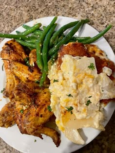 chicken, mashed potatoes and green beans on a white plate